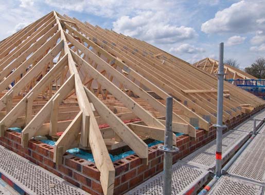 view of exposed roof trusses on new build development